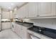 Kitchen featuring bright cabinetry, stainless steel appliances, and breakfast bar at 2630 Tarpon Cove Dr # 211, Punta Gorda, FL 33950