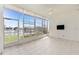 Light-filled sunroom with tile flooring, ceiling fan, and serene view of the waterway at 2630 Tarpon Cove Dr # 211, Punta Gorda, FL 33950
