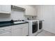 Functional laundry room with modern washer and dryer units and ample cabinet space at 2630 Tarpon Cove Dr # 211, Punta Gorda, FL 33950