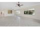Spacious living room with tile floors, a ceiling fan, and large windows that let in plenty of natural light at 2630 Tarpon Cove Dr # 211, Punta Gorda, FL 33950