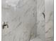 Close-up of shower with elegant marble-look tile and modern fixtures at 2630 Tarpon Cove Dr # 211, Punta Gorda, FL 33950