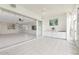 Bright sunroom features tile floors, white cabinets, wet bar, and sliding glass doors to the living area at 2630 Tarpon Cove Dr # 211, Punta Gorda, FL 33950