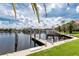 Idyllic waterfront scene with private boat docks, lush tropical foliage, and upscale homes at 2630 Tarpon Cove Dr # 211, Punta Gorda, FL 33950