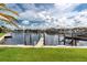 Scenic waterfront featuring well-maintained docks, lush greenery, and beautiful waterfront residences at 2630 Tarpon Cove Dr # 211, Punta Gorda, FL 33950