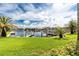 Picturesque waterfront view with lush landscaping and private boat docks under a sunny sky at 2630 Tarpon Cove Dr # 211, Punta Gorda, FL 33950