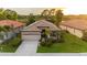 Inviting single story home boasting a tile roof, attached two car garage, and mature landscaping at 2712 Arugula Dr, North Port, FL 34289