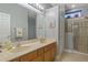 Bathroom featuring a double sink vanity, walk-in shower, and neutral wall colors at 2712 Arugula Dr, North Port, FL 34289