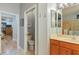 Bathroom featuring a toilet room, lighted vanity, and glass shower with decorative tile at 2712 Arugula Dr, North Port, FL 34289