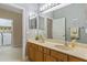 Bright bathroom featuring a double sink vanity with ample storage and laundry room access at 2712 Arugula Dr, North Port, FL 34289
