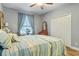 Comfortable bedroom featuring coastal-themed decor, wood floors, closet and ample natural light at 2712 Arugula Dr, North Port, FL 34289