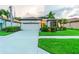 Charming single-story home featuring a well-manicured lawn, tile roof and attached two-car garage at 2712 Arugula Dr, North Port, FL 34289