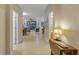 Bright hallway featuring neutral-toned walls, tile floors, and natural light filtering from the living area at 2712 Arugula Dr, North Port, FL 34289