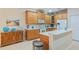 Bright eat-in kitchen features tile floors, stainless steel appliances, and wood cabinetry at 2712 Arugula Dr, North Port, FL 34289