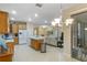 Open kitchen features tile floors, stainless steel appliances, and wood cabinets at 2712 Arugula Dr, North Port, FL 34289