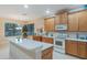 Charming kitchen with a large island, modern appliances, and ample cabinet space by the window at 2712 Arugula Dr, North Port, FL 34289