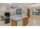 Open-concept kitchen seamlessly flows into the living room offering a perfect space for entertaining at 2712 Arugula Dr, North Port, FL 34289