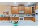 Eat-in kitchen features tile floors, stainless steel appliances, and wood cabinets at 2712 Arugula Dr, North Port, FL 34289