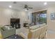 Cozy living room with comfortable seating and views of the screened lanai and pool area at 2712 Arugula Dr, North Port, FL 34289