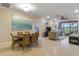 Inviting living room with dining area flowing into a cozy seating area, perfect for relaxing and entertaining at 2712 Arugula Dr, North Port, FL 34289