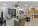 Comfortable living room featuring a neutral color palette, seamless flow to outdoor patio and access to kitchen at 2712 Arugula Dr, North Port, FL 34289