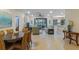 Open-concept living space with dining area, neutral tones, and seamless transition to outdoor patio at 2712 Arugula Dr, North Port, FL 34289