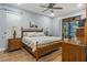 Main bedroom featuring wood floors, ceiling fan, and lanai access at 2712 Arugula Dr, North Port, FL 34289