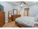 Main bedroom featuring wood floors, ceiling fan, and ensuite bathroom access at 2712 Arugula Dr, North Port, FL 34289
