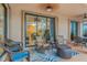 Relaxing screened-in patio with ceiling fans, comfortable seating, and glass doors at 2712 Arugula Dr, North Port, FL 34289