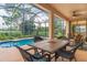 Inviting screened lanai with a pool, outdoor seating, and serene landscaping at 2712 Arugula Dr, North Port, FL 34289