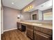 Bathroom boasts a double vanity with granite countertop and dark wood cabinets at 27896 Arrowhead Cir, Punta Gorda, FL 33982