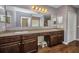 Bathroom offers a dual sink vanity, ample counter space, and wood-look flooring at 27896 Arrowhead Cir, Punta Gorda, FL 33982