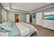 Cozy bedroom featuring carpet flooring, a tray ceiling, and a dresser with a television at 27896 Arrowhead Cir, Punta Gorda, FL 33982