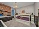 Cozy bedroom features a brick accent wall and stylish decor at 27896 Arrowhead Cir, Punta Gorda, FL 33982