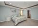 Spacious bedroom showcases carpet, tray ceiling, and access to an ensuite bathroom at 27896 Arrowhead Cir, Punta Gorda, FL 33982