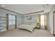 Relaxing bedroom with tray ceiling, carpet flooring, and natural light from windows at 27896 Arrowhead Cir, Punta Gorda, FL 33982