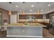 Open kitchen featuring a large island with granite countertops, wood cabinets, and stainless steel appliances at 27896 Arrowhead Cir, Punta Gorda, FL 33982