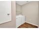 Functional laundry room with full-size washer and dryer, and storage shelf at 27896 Arrowhead Cir, Punta Gorda, FL 33982
