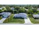 Aerial view of a charming home with lush greenery and mature trees at 3085 Arrowhead Rd, Venice, FL 34293