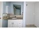 Bathroom with white cabinets, granite counters, and subway tile in shower at 3085 Arrowhead Rd, Venice, FL 34293