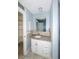 Bathroom featuring granite countertops, white cabinets, and bright natural light at 3085 Arrowhead Rd, Venice, FL 34293