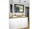 Bathroom featuring a double vanity with granite counters and a large mirror at 3085 Arrowhead Rd, Venice, FL 34293
