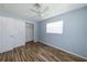 Bedroom with a ceiling fan, closet and wood flooring at 3085 Arrowhead Rd, Venice, FL 34293