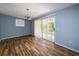 Bright dining room featuring laminate flooring, a chandelier, and sliding glass doors leading to the patio at 3085 Arrowhead Rd, Venice, FL 34293