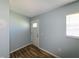 Entryway featuring wood floors, light blue walls, and a front door at 3085 Arrowhead Rd, Venice, FL 34293