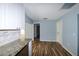 Kitchen with granite countertops, white cabinets and wood flooring at 3085 Arrowhead Rd, Venice, FL 34293