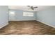 Spacious living room featuring laminate flooring, a ceiling fan, and a bright atmosphere with natural light at 3085 Arrowhead Rd, Venice, FL 34293