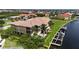 Waterfront condo complex on canal featuring a swimming pool, lush tropical landscaping and private boat docks at 3308 Purple Martin Dr # 121, Punta Gorda, FL 33950