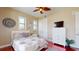 Cozy bedroom features a ceiling fan, bed, windows with blinds, and a TV on a chest of drawers at 3308 Purple Martin Dr # 121, Punta Gorda, FL 33950
