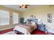 Serene bedroom featuring hardwood floors, a ceiling fan, and large windows with natural light at 3308 Purple Martin Dr # 121, Punta Gorda, FL 33950