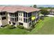 Beautiful condo building featuring screened balconies, tropical landscaping, and covered parking at 3308 Purple Martin Dr # 121, Punta Gorda, FL 33950